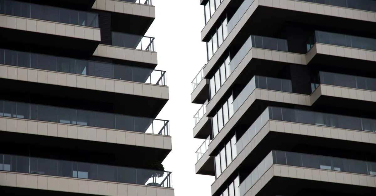 Striking architectural view of glass and metal high-rise buildings showcasing modern urban design.